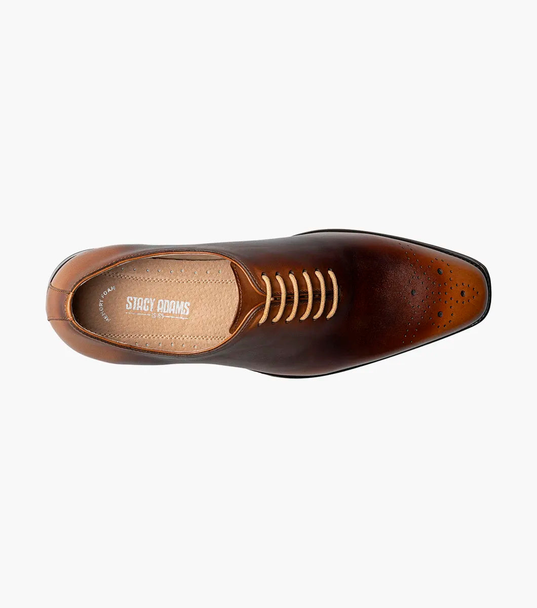 The STACY ADAMS Hallquist Plain Toe Oxford in toffee (25742-235) is a brown leather dress shoe with closed lacing, a low heel, toe perforations, and memory foam insole, shown against a white background.