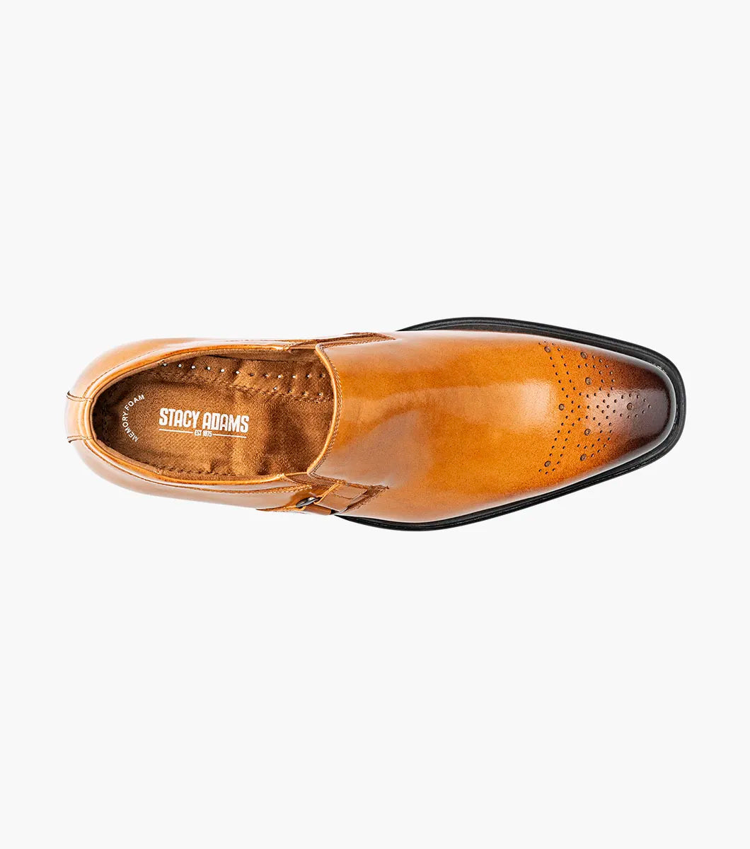 The Stacy Adams Alistair Plain Toe Ornament Slip On (Tan, 25792-240) by STACY ADAMS is a single tan calf leather dress shoe with a pointed toe, decorative perforations, and a side buckle, featuring a comfortable memory foam insole, displayed on a white background.