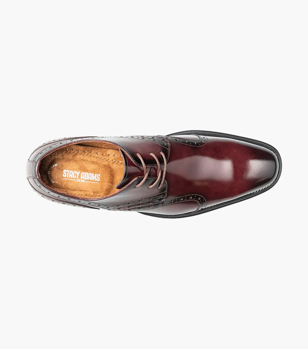 The Stacy Adams Alexander Plain Toe Oxford in Burgundy (style 25791-601) is a men’s dress shoe crafted from glossy oxblood calf leather, featuring brogue detailing, a lace-up closure, and a low black heel, displayed against a plain white background.