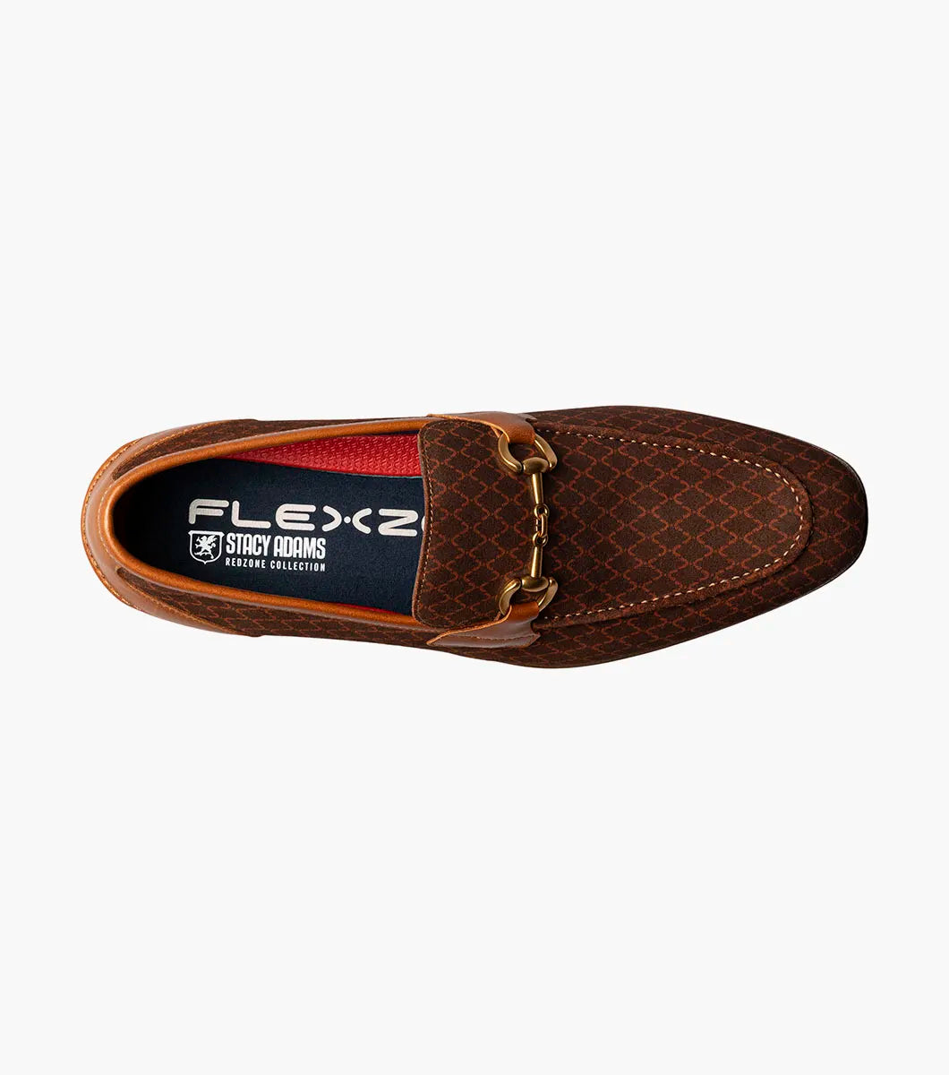 The Stacy Adams Brinkley Moc Toe Bit Slip On in tan features a patterned suede upper, leather trim, gold horsebit detail, low heel, FlexZone removable footbed, and red lining.