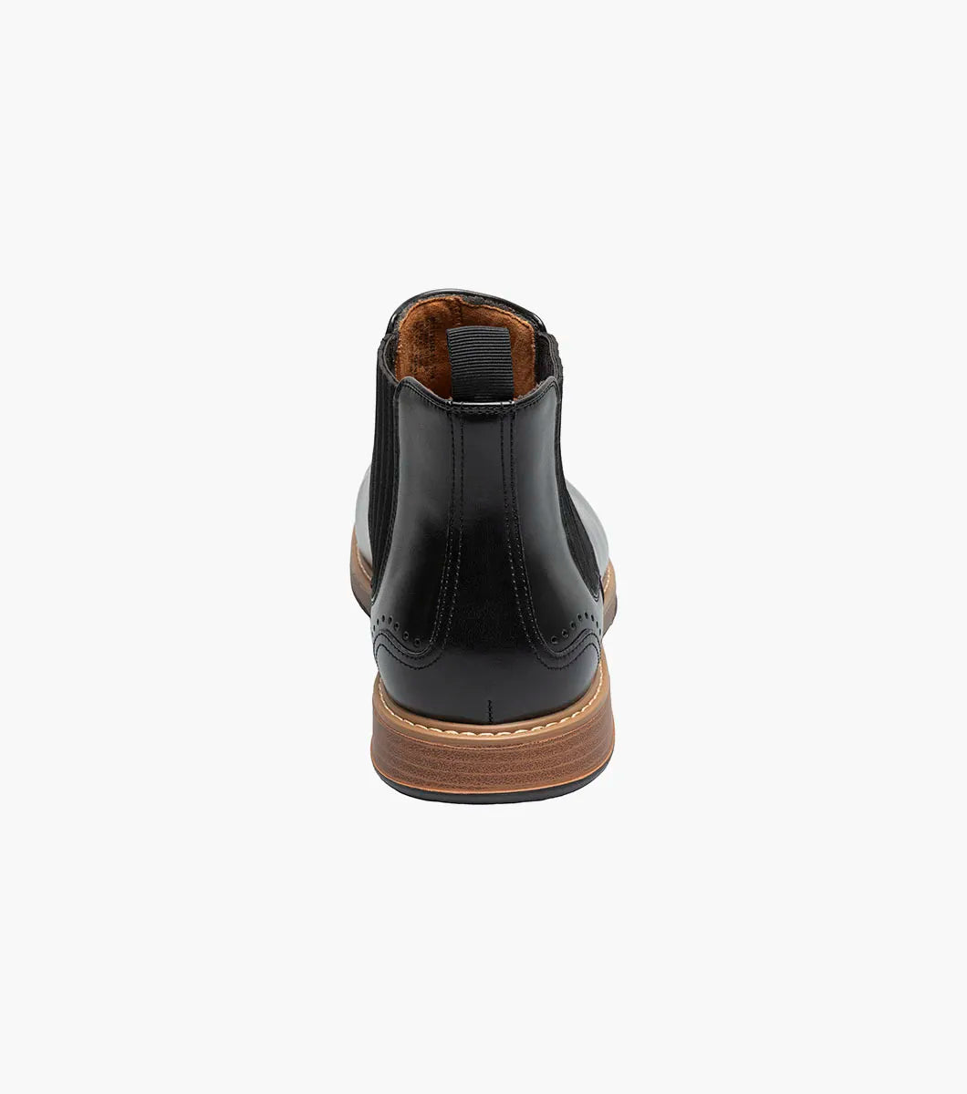 The STACY ADAMS Platt Plain Toe Chelsea Boot (Black, 25755-001) features sleek leather, elastic side panels, a brown sole, and a back pull tab—an elegant choice for any men’s boot collection.