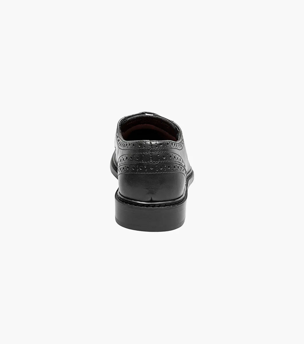 The Stacy Adams Giorgetti Plain Toe Oxford in black features lizard print leather, a low heel, lace-up closure, textured accents by the laces, and a cushioned footbed, shown on a plain white background.