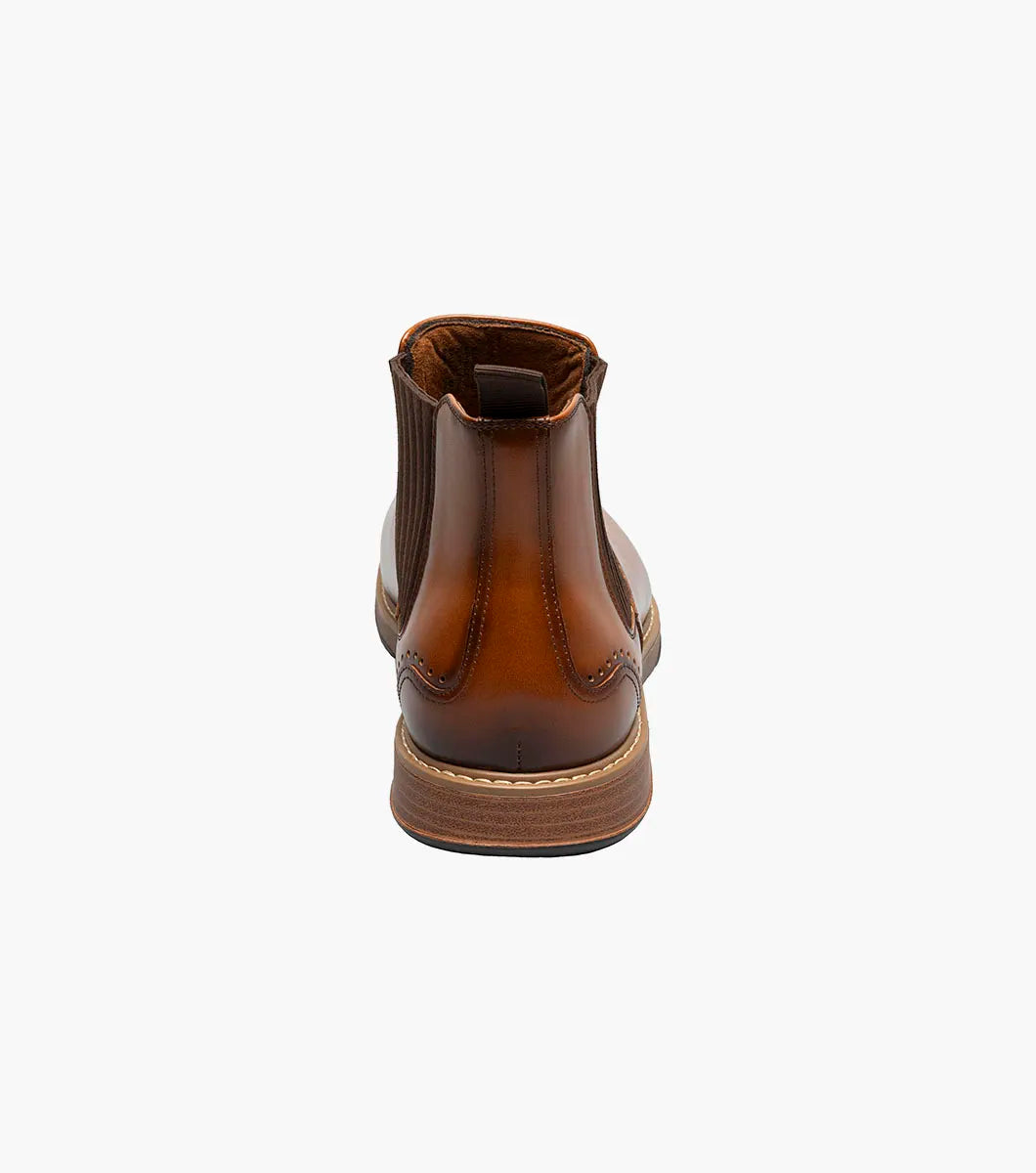 The Stacy Adams Platt Plain Toe Chelsea Boot in cognac features elastic side panels, a back pull tab, low stacked heel, and a RedZone removable footbed; shown on a white background.