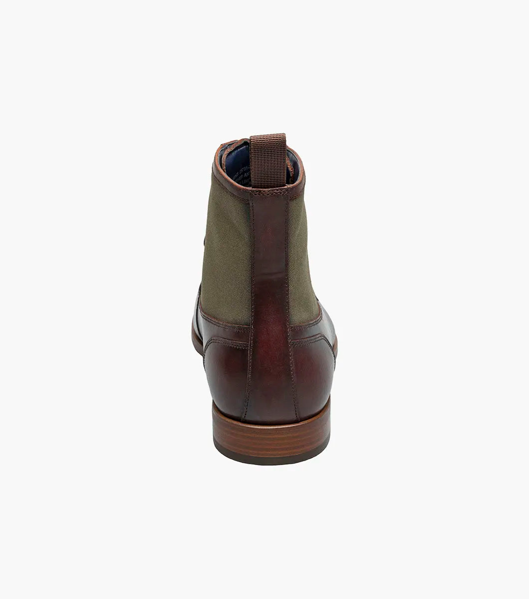 The Stacy Adams Brumley Moc Toe Lace Up Boot in Brown Multi features burnished leather and olive green fabric, a lace-up closure, cushioned footbed, and low stacked heel for lasting comfort and style.
