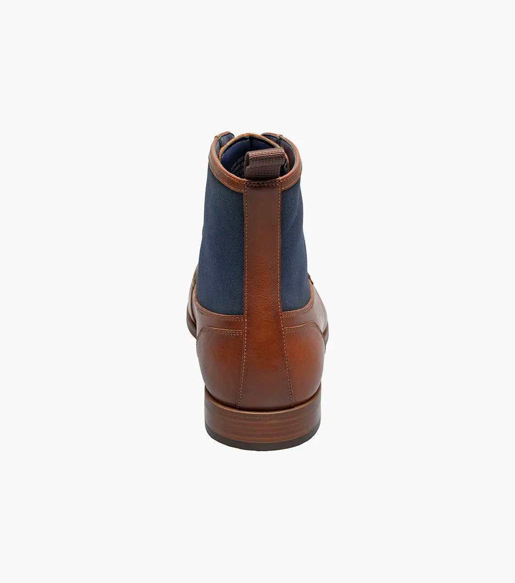 The STACY ADAMS Brumley Moc Toe Lace Up Boot in Tan Multi features burnished leather and navy fabric, a low wooden heel, cushioned footbed, and fabric pull tab.