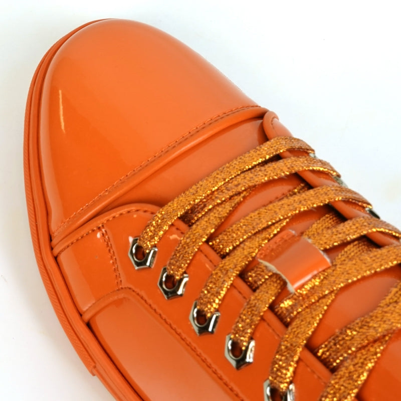 The Fiesso FI-2415-2 Orange Patent Lace-up Low-Cut Leather Sneaker boasts shiny orange patent leather and matching laces, designed for men's casual wear. Set against a crisp white backdrop, these sneakers stylishly blend comfort and trendiness.