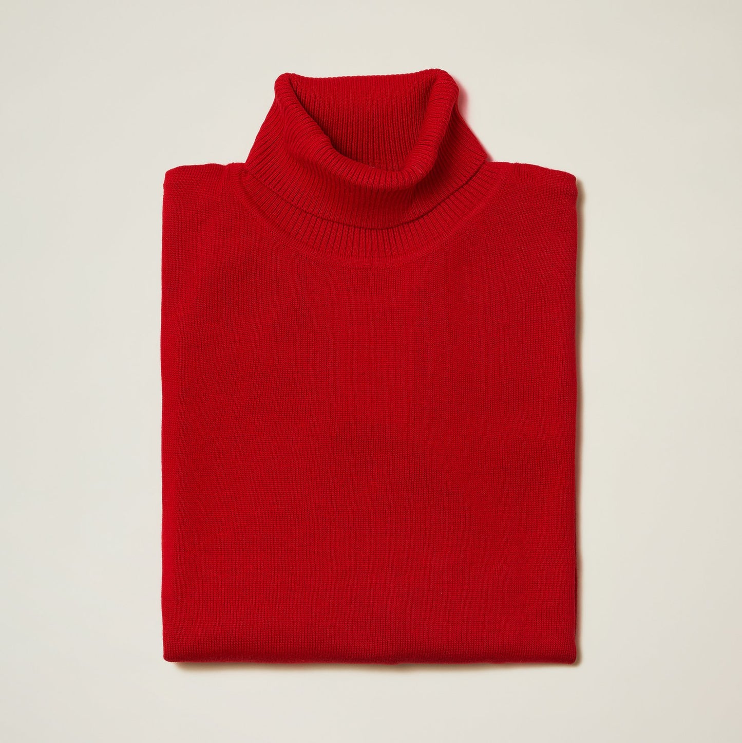 The Inserch Cotton Blend Turtleneck Sweater Red 4708 by Inserch, known for its soft cotton blend, is neatly folded on a light surface, delivering a refined appearance.