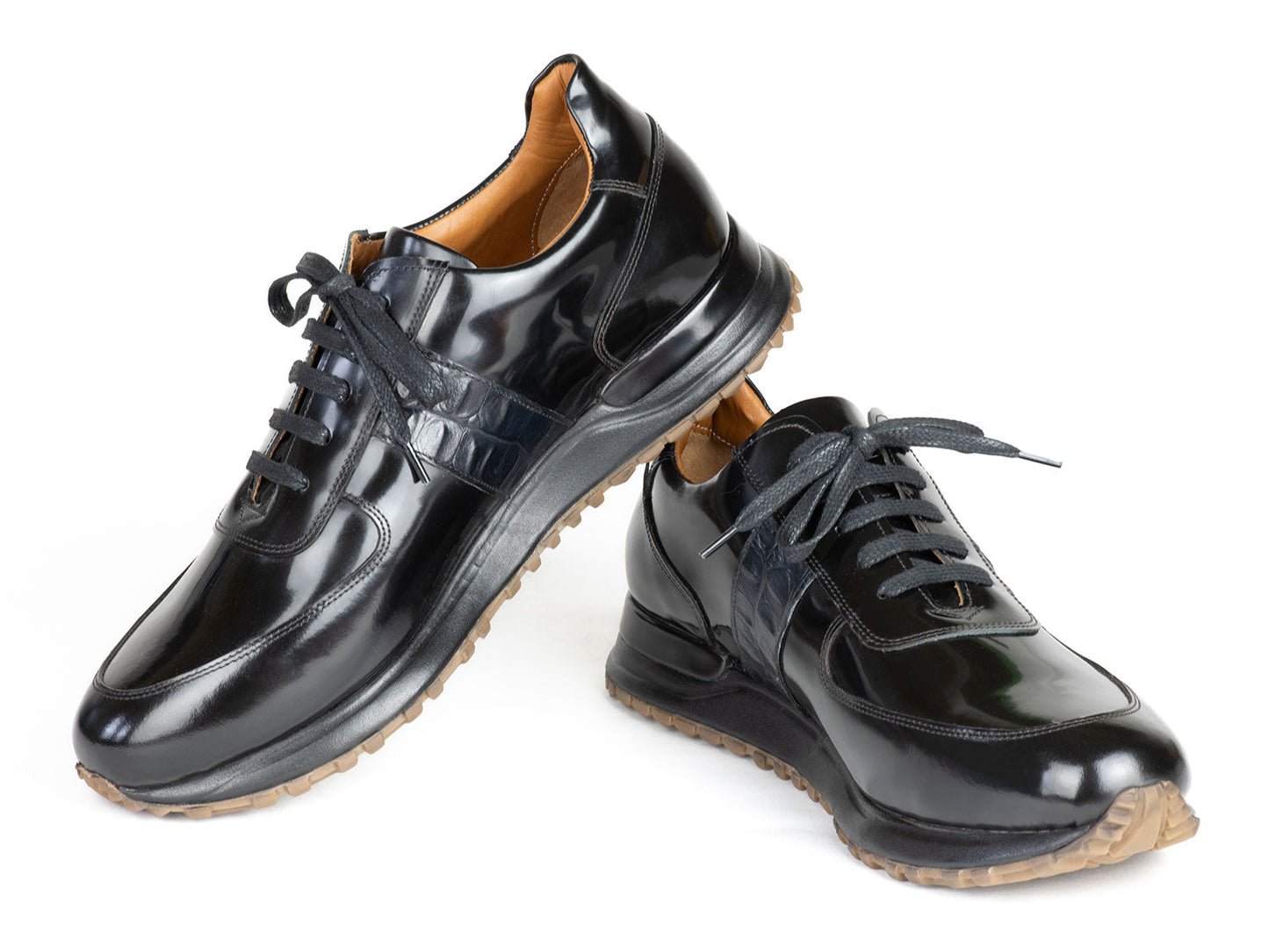 The Paul Parkman Men's Black Polished Leather Sneakers - LP208BLK, by Paul Parkman, showcase shiny black leather with brown rubber soles, complete with laces and a patterned side panel, embodying the essence of luxury fashion sneakers.