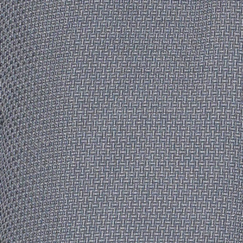 A man poses indoors against a light decorative wall, wearing the INSOMNIA CAVALLI 2PC Charcoal Leisure Suit by Insomnia—a matching poly-rayon blend suit with a textured button-up shirt with two pockets and coordinating grey pants.