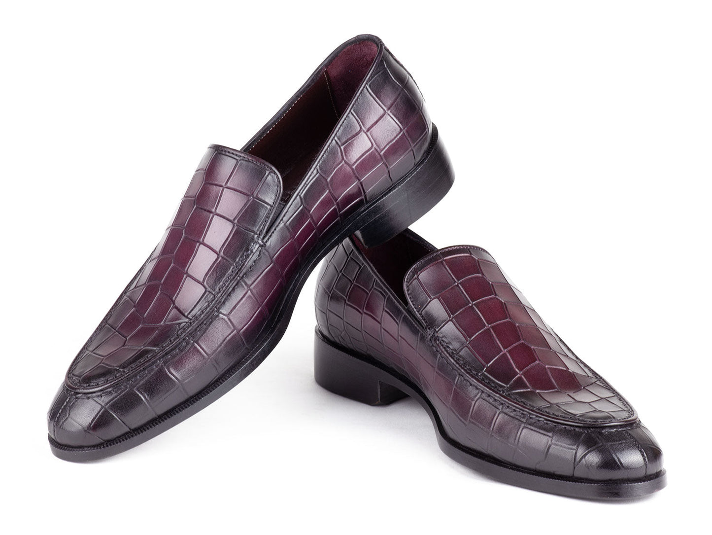 A pair of Paul Parkman loafers in luxurious purple croco-textured leather, featuring sleek black soles, elegantly showcased side by side.