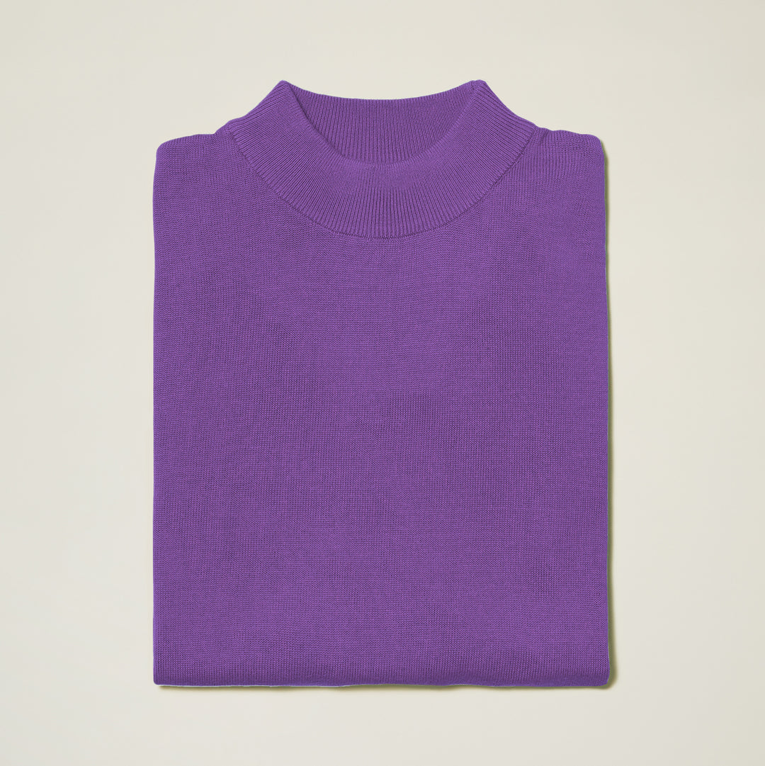 The Inserch Cotton Blend Mock Neck Sweater in Amethyst (4308-00180) features a high ribbed neckline, neatly folded and displayed on a plain light background.