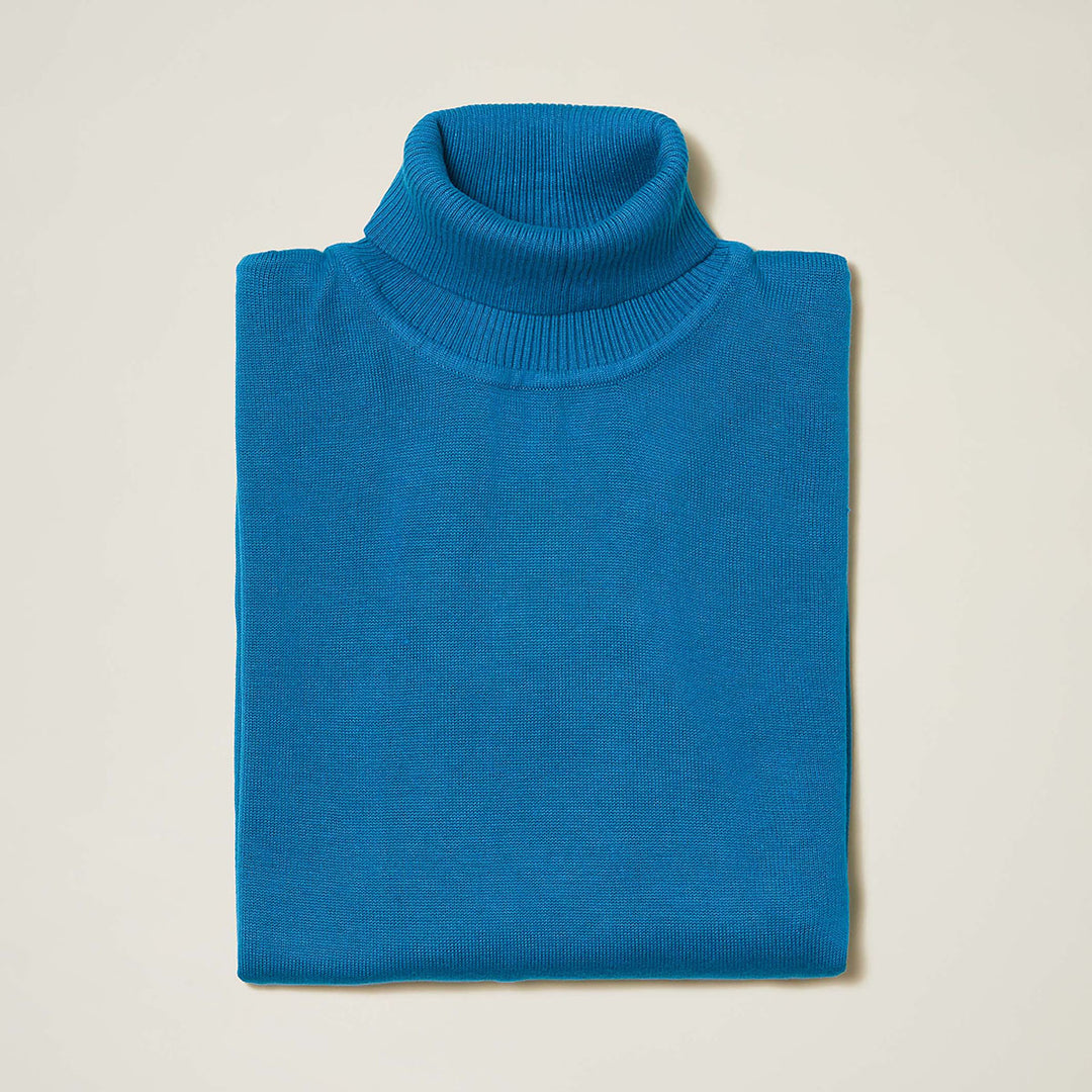 The Inserch Cotton Blend Turtleneck Sweater in True Blue (style 4708) by Inserch, made from a soft cotton-acrylic blend, is neatly folded and displayed against a plain light-colored background.