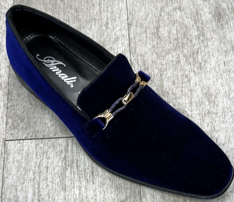 An exquisite dark purple velvet loafer with a gold chain detail, crafted from genuine leather by UNIQUE DESIGN MENSWEAR, rests elegantly on a gray tiled floor.