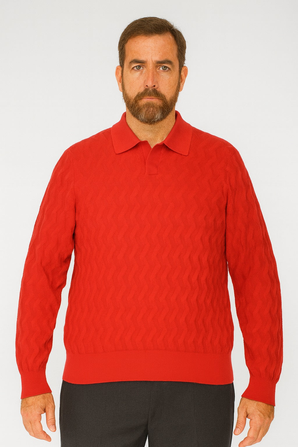 A bearded man stands facing forward in a Bassiri Long Sleeve Collar Neck Red Sweater 639 and dark pants against a plain light background.