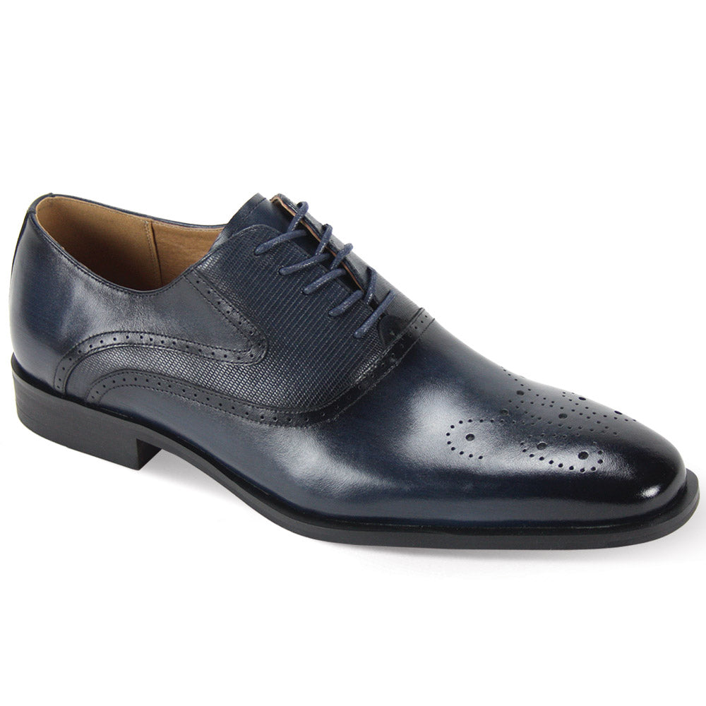 The Giorgio Venturi 6996 Navy Leather Shoes are a dark blue leather oxford dress shoe with a medallion toe, decorative perforations on the side, and laces.