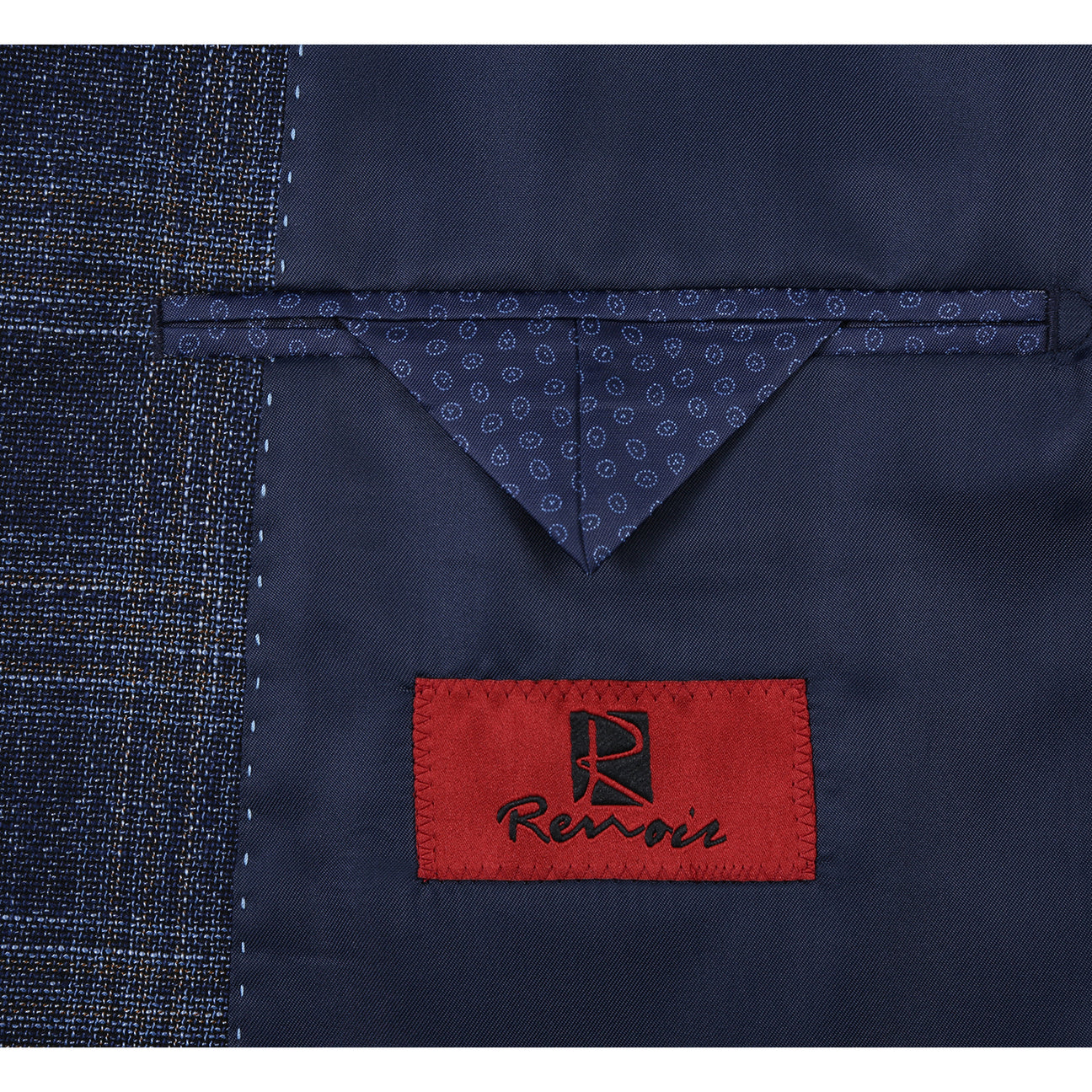 Displayed elegantly on a mannequin, the Renoir "Alessandro Vitello" Navy Blazer is paired with a white shirt, blue polka-dot tie, and matching pocket square.