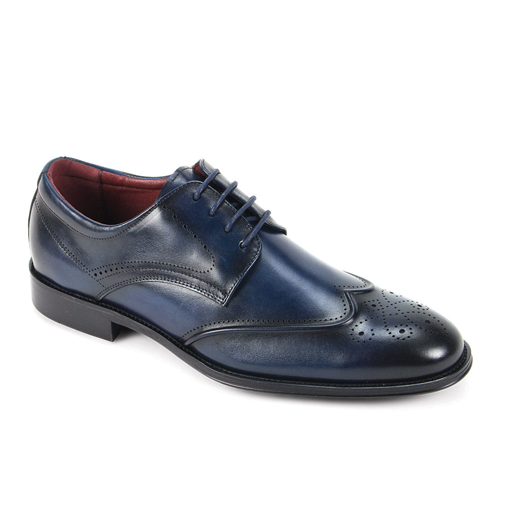 The Giorgio Venturi Giorgio 7077 Navy Leather Shoes are genuine navy blue wingtips with a black sole, decorative perforations, and lace-up closure, displayed on a white background.