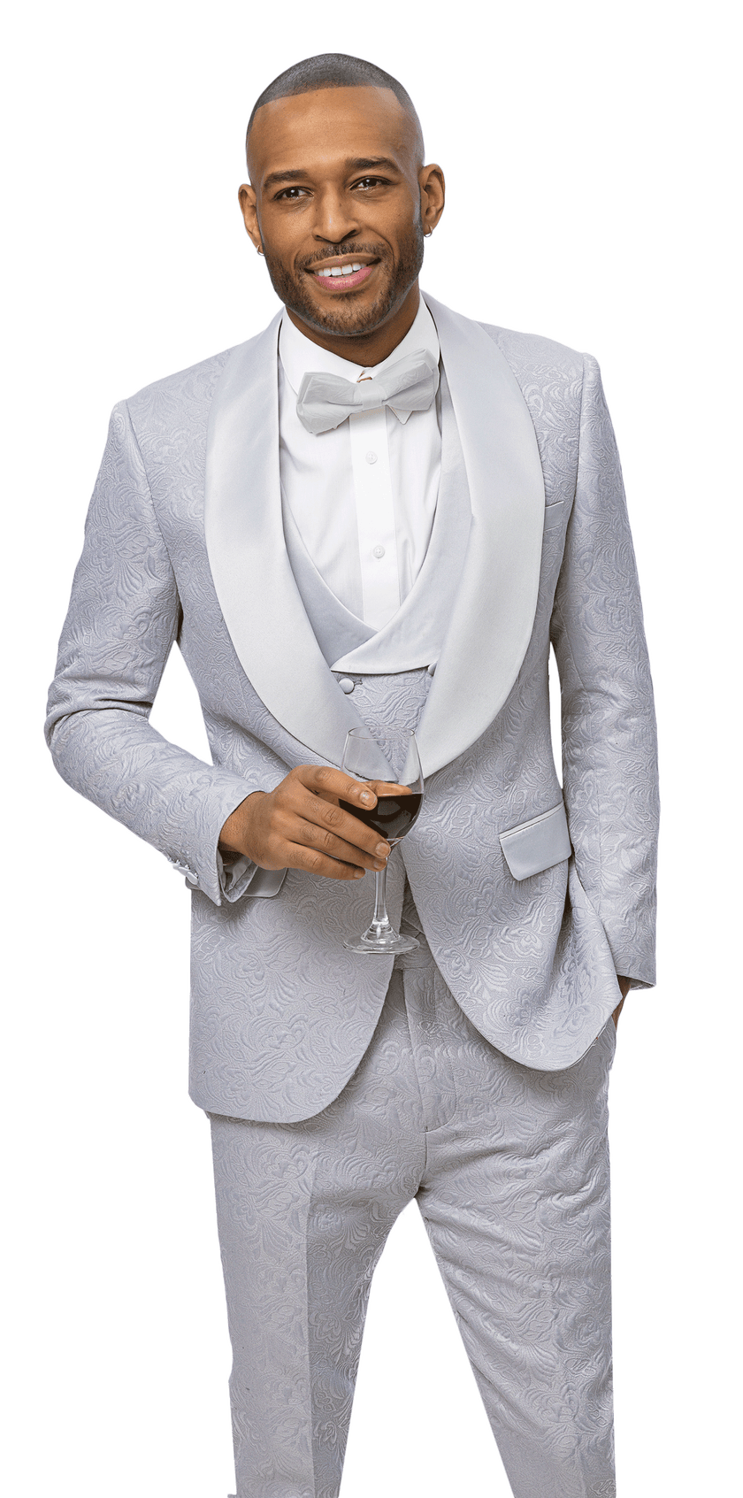 A man in the EJ Samuel Silver Suit JP138 by EJ SAMUEL—light gray with a patterned texture, satin shawl lapel, white shirt, and bow tie—holds red wine and stands confidently, embodying timeless elegance in this 3-piece ensemble.