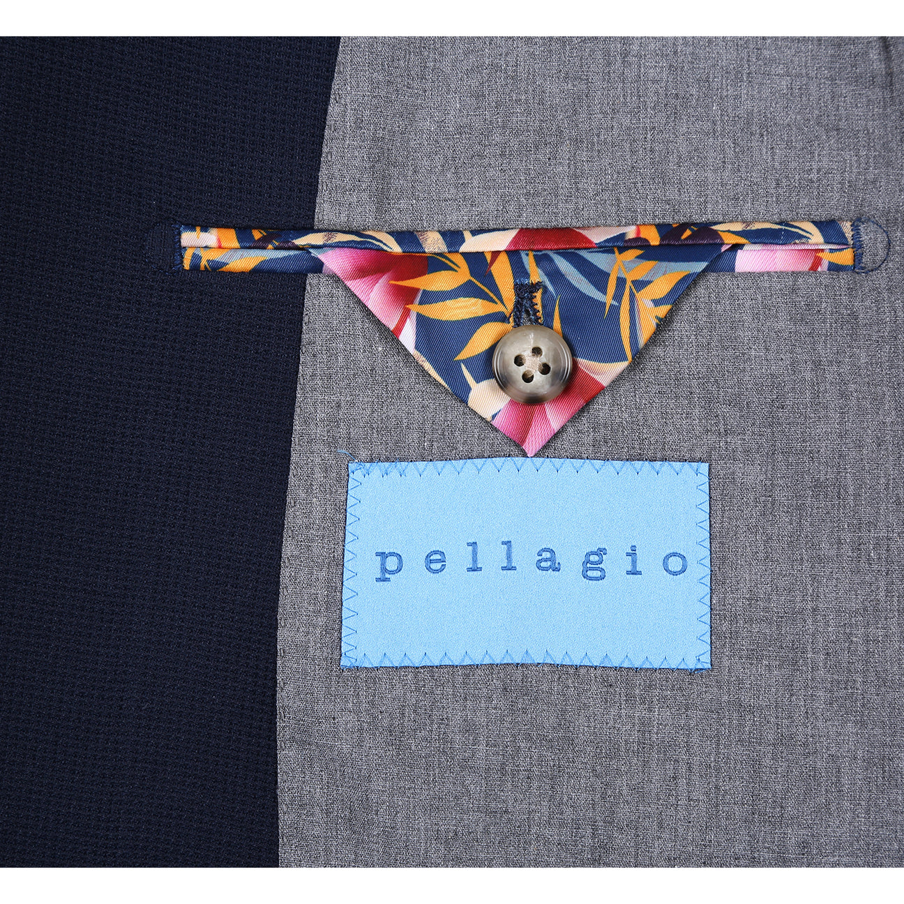 The Pellagio Men's Half Canvas Blazer Navy PS25-17, a single-breasted jacket with notched lapel and two buttons, is styled with a white dress shirt, patterned beige tie, and colorful pocket square on a display mannequin.