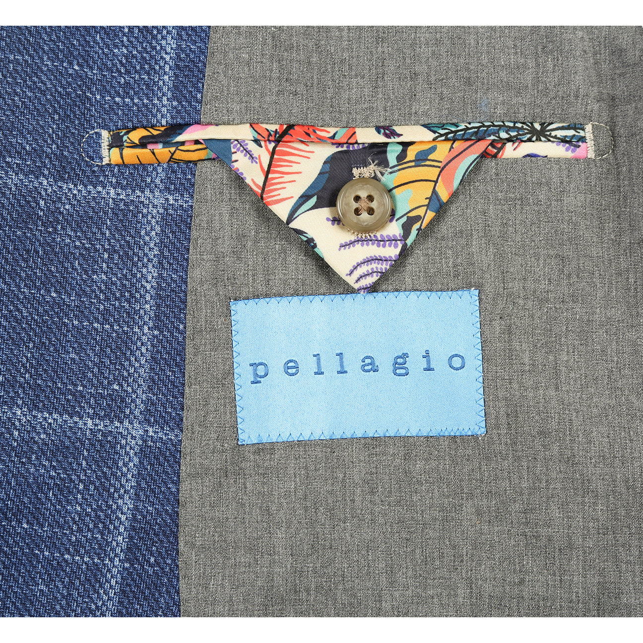 The Pellagio Riserva JKT Blazer PS25-6 by Pellagio is a blue plaid slim fit blazer with notched lapel, single button closure, and chest pocket with pocket square, styled over a white shirt and striped tie on a mannequin.