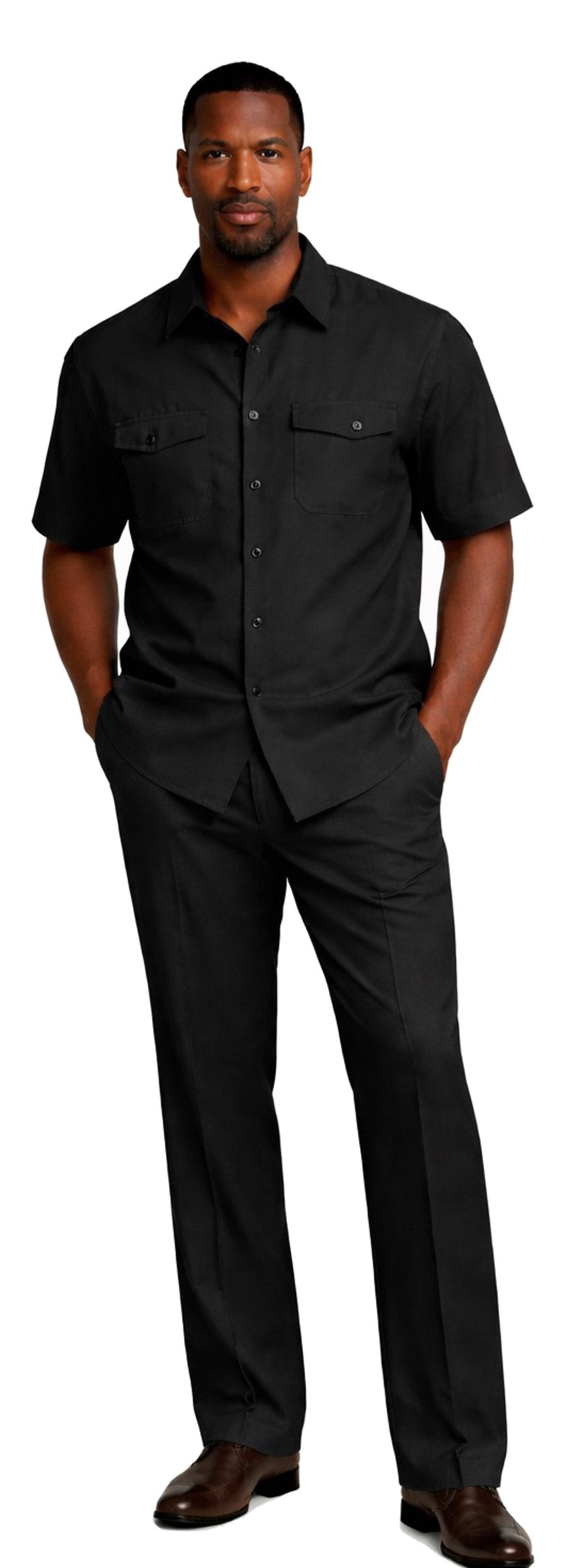 A man stands with hands in pockets, wearing the Bassiri Black 2pc Set A 145 by Bassiri, paired with brown shoes.