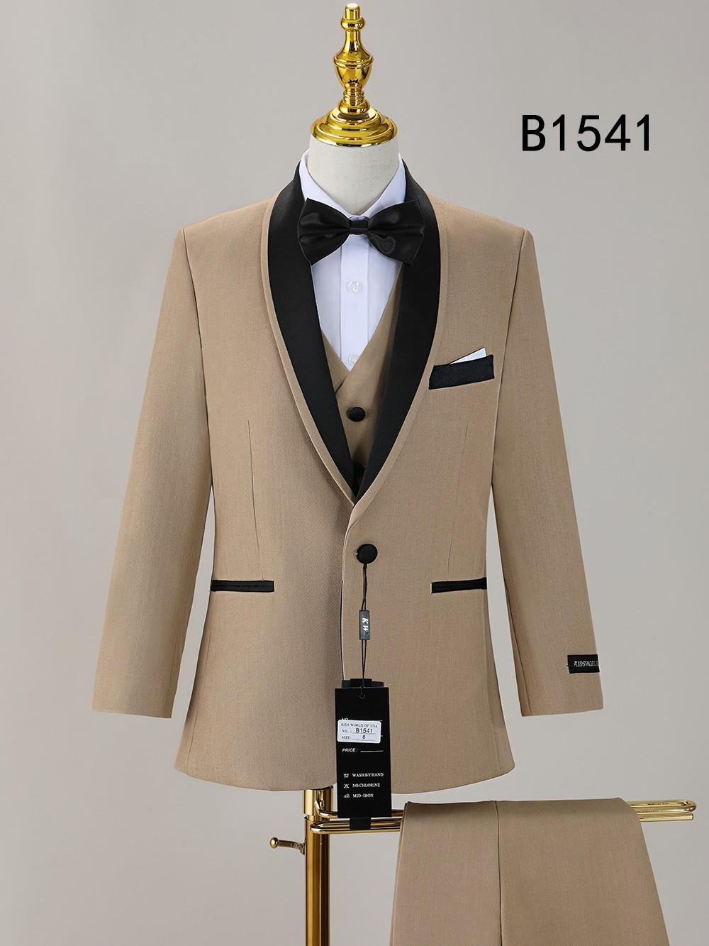 The BOY SUIT 5-PC SET B1541 by Unique Design Menswear features a tan tuxedo jacket with black lapels, black bow tie, white dress shirt, beige vest, and matching pants—perfect formal wear for boys.