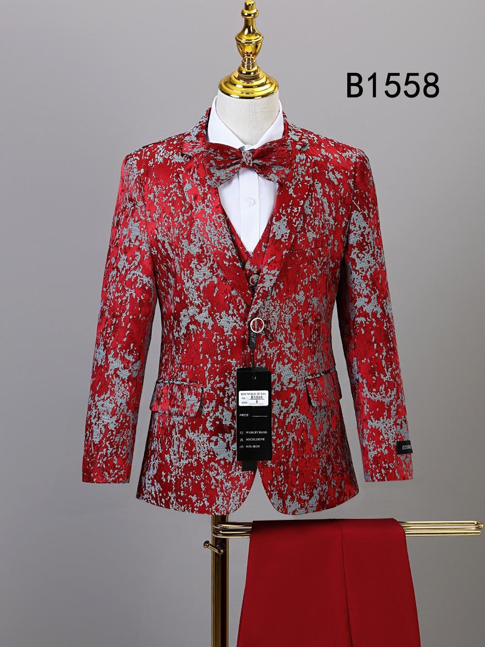 Unique Design Menswear BOY SUIT 5-PC SET B1558: Red and silver patterned tuxedo jacket, matching bowtie and vest on mannequin with red trousers—an eye-catching boys' formal suit for special occasions.