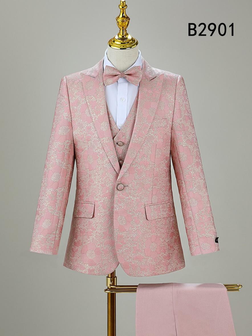 The BOY SUIT 5-PC SET B2901 by Unique Design Menswear is a pink floral boys' formal suit featuring a coordinating bow tie, displayed on a mannequin with gold stand and matching pants draped below.