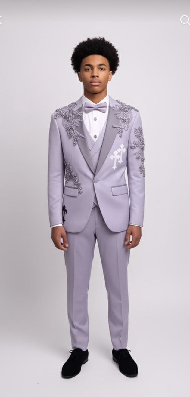 A young man faces forward against a plain background, wearing the Unique Design Menswear Custom Prom Suit in lavender with purple rhinestones, styled with a white shirt and bow tie.