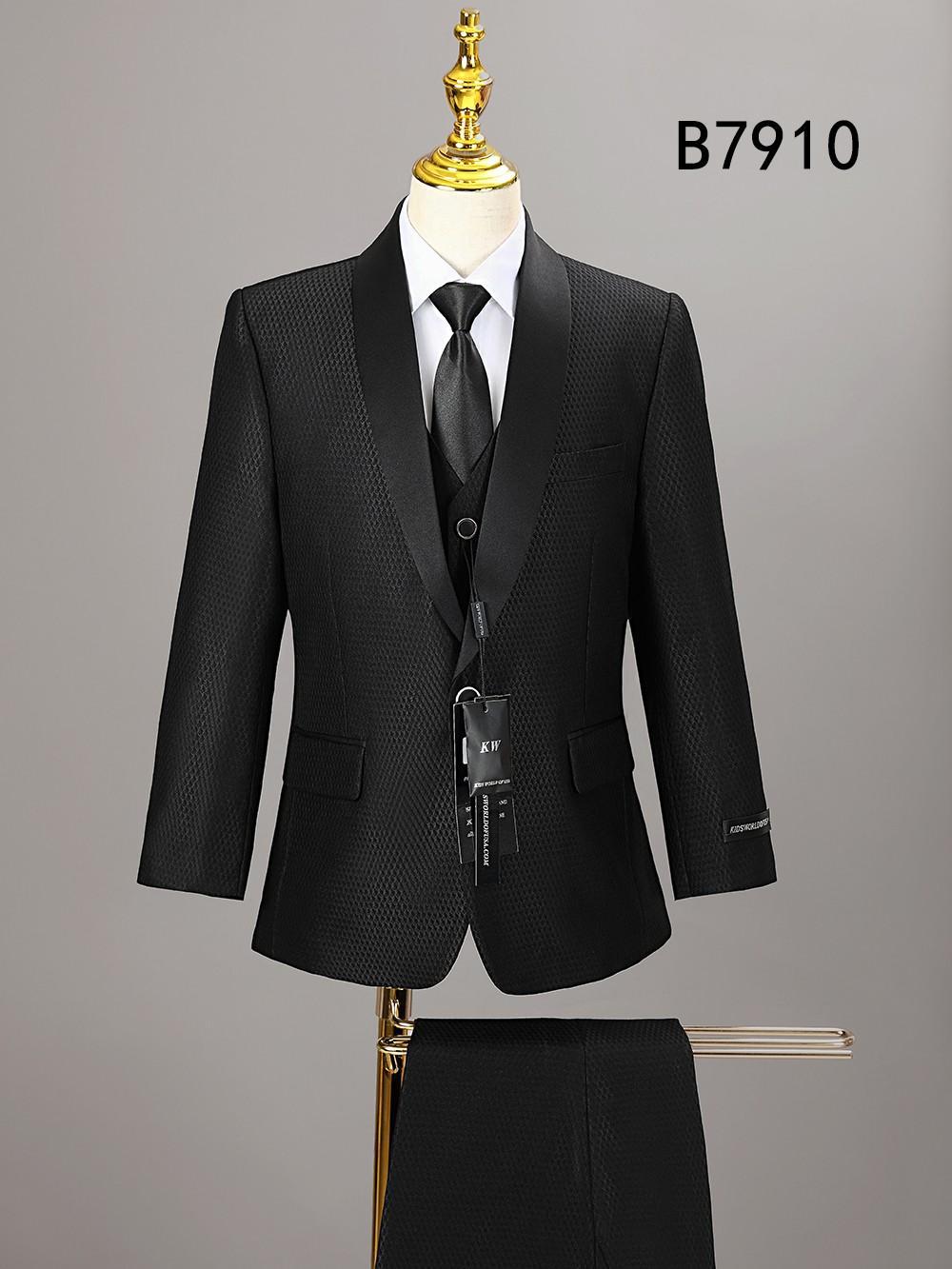The Unique Design Menswear BOY SUIT 5-PC SET B7910 features a black textured formal suit with satin lapels, white shirt, black tie, and pants, showcased on a gold stand. Product code "B7910" appears in the top right corner.