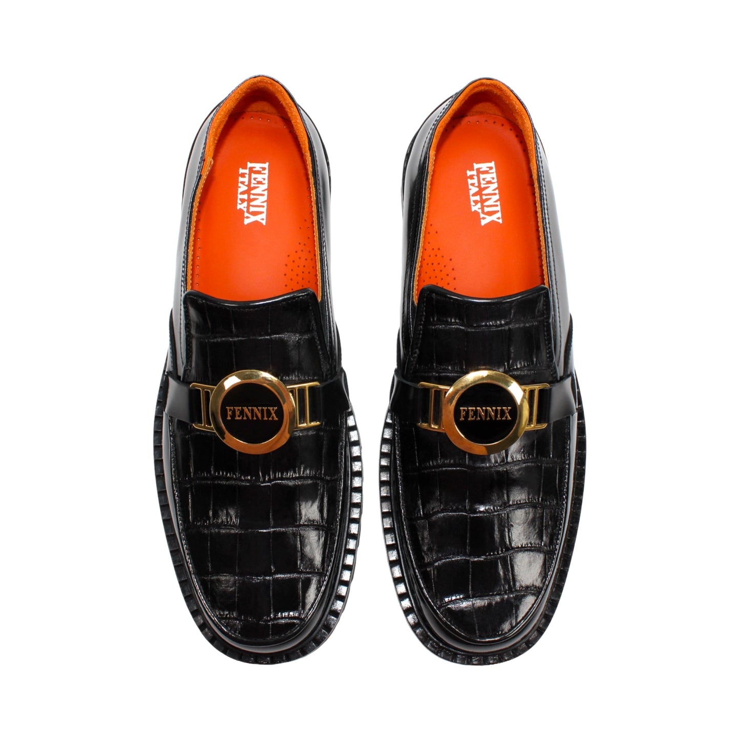The Fennix Brant Black by Fennix of Italy is an Italian-crafted black patent loafer featuring a textured pattern, thick ridged sole, gold hardware buckle detail, and an orange inner lining, displayed in profile against a white background.