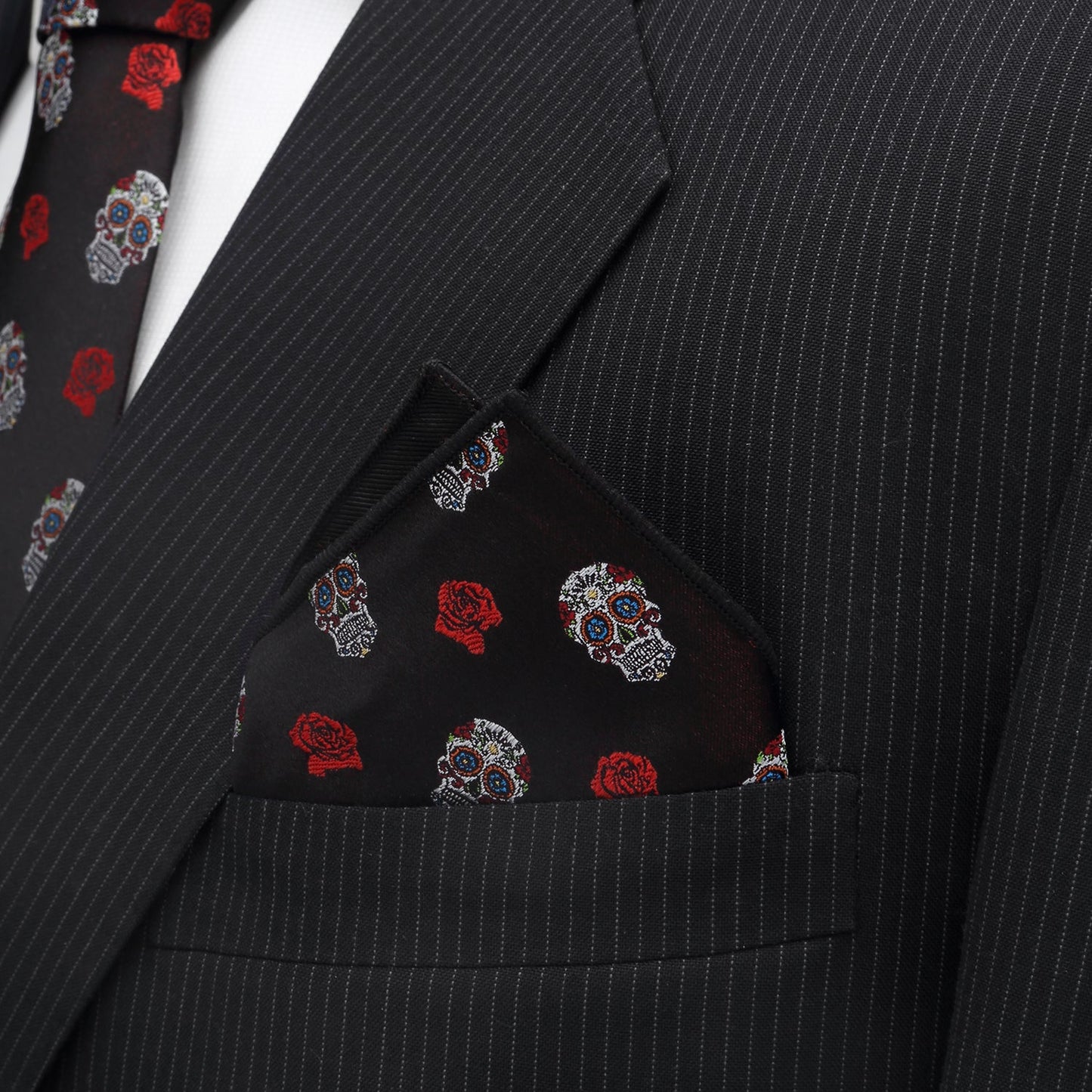 The Sugar Skull Pocket Square by Cufflinks.com features a dark red fabric with white skulls and red roses—perfect as a Day of the Dead or calavera accessory.