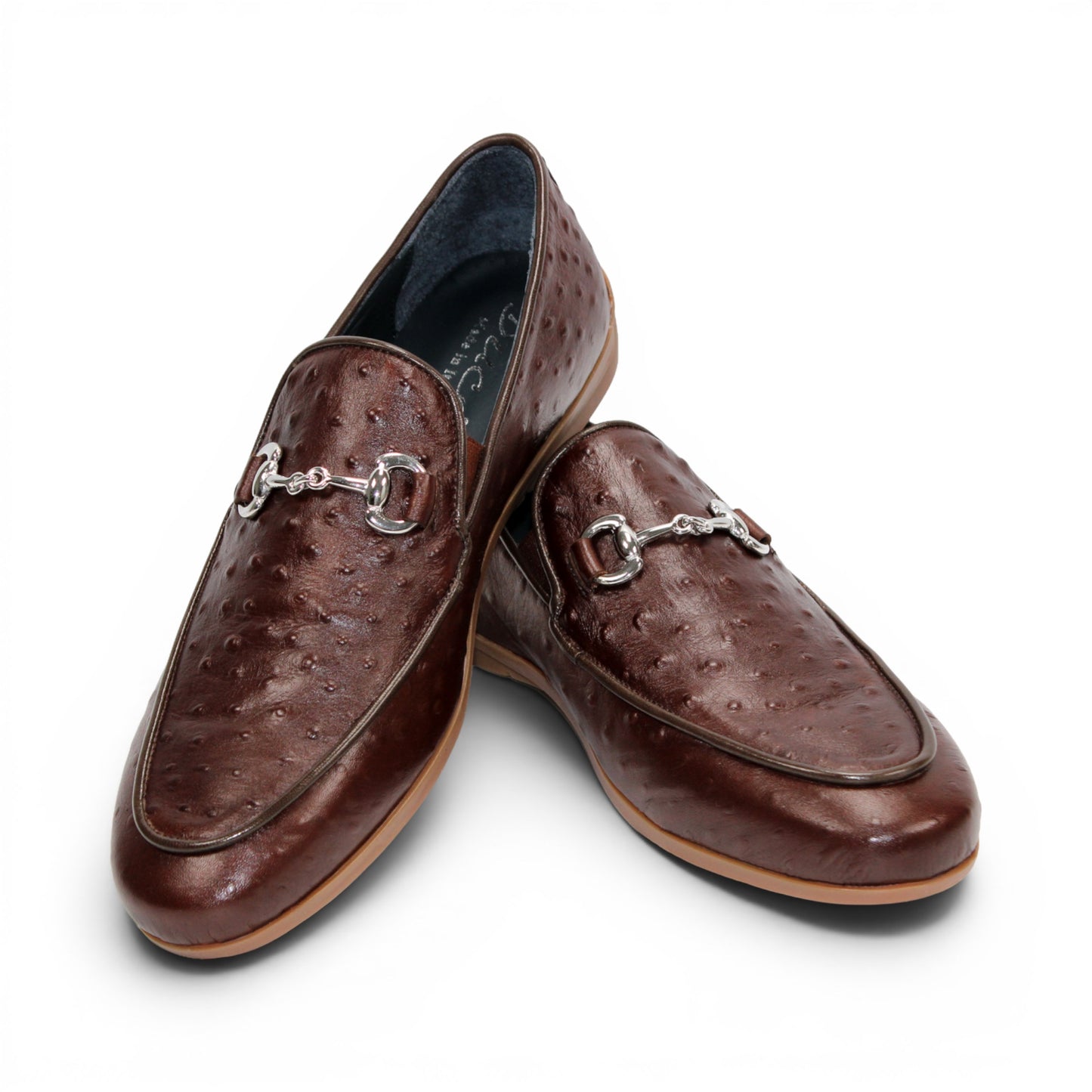 The Duca Di Matiste Duca Cortona Marrone features a luxurious brown leather loafer design with a textured Stampa Struzzo ostrich pattern, an elegant decorative metal bit on the upper, and a tan rubber sole. Displayed on a white background, this shoe exemplifies the finest Italian craftsmanship in men's luxury leather footwear.