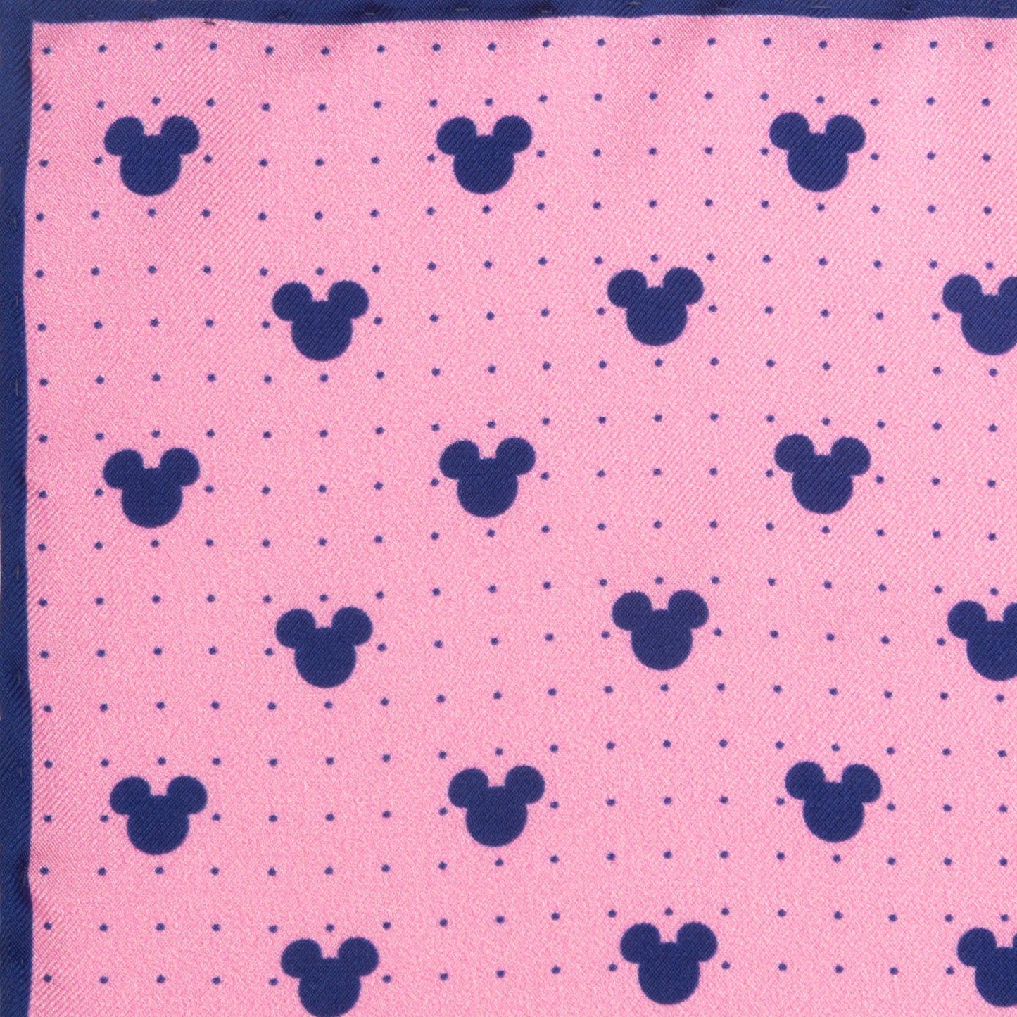 The Disney Mickey Mouse Dot Pink Pocket Square by Cufflinks.com features navy Mickey Mouse silhouettes and dots on pink silk, bordered in navy blue—a stylish Disney accessory.