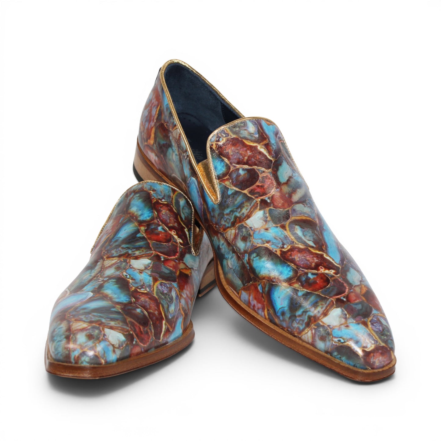 The Emilio Franco EF483 Marble by Emilio Franco is a loafer-style dress shoe showcasing a multicolored, abstract marble calf print in blue, red, and brown tones. It features a low wooden heel, leather sole, and slip-on design—an impressive display of Italian footwear craftsmanship.