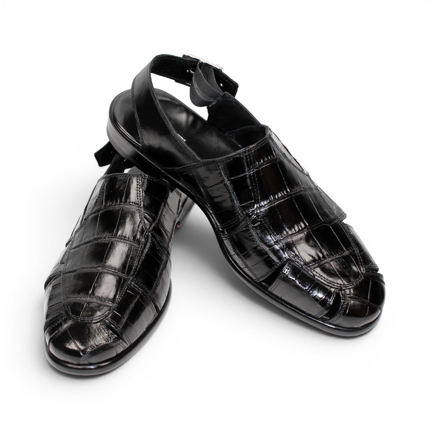 Introducing the Fennix F131 Black sandal by Fennix of Italy—a black leather design featuring a closed toe, open heel, silver buckle strap, and a flat sole, elegantly displayed on a white background. Crafted for those who value luxury footwear, this sandal offers refined style and comfort with every step.