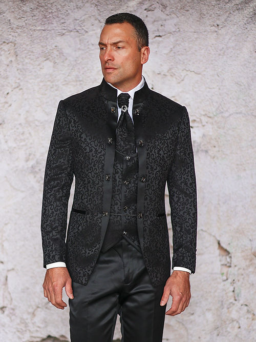 A man dons the Insomnia MANZINI HAVANA 3-Piece Slim Fit Shiny Satin Pattern Banded Collar Black Suit standing against a textured, light-colored wall.