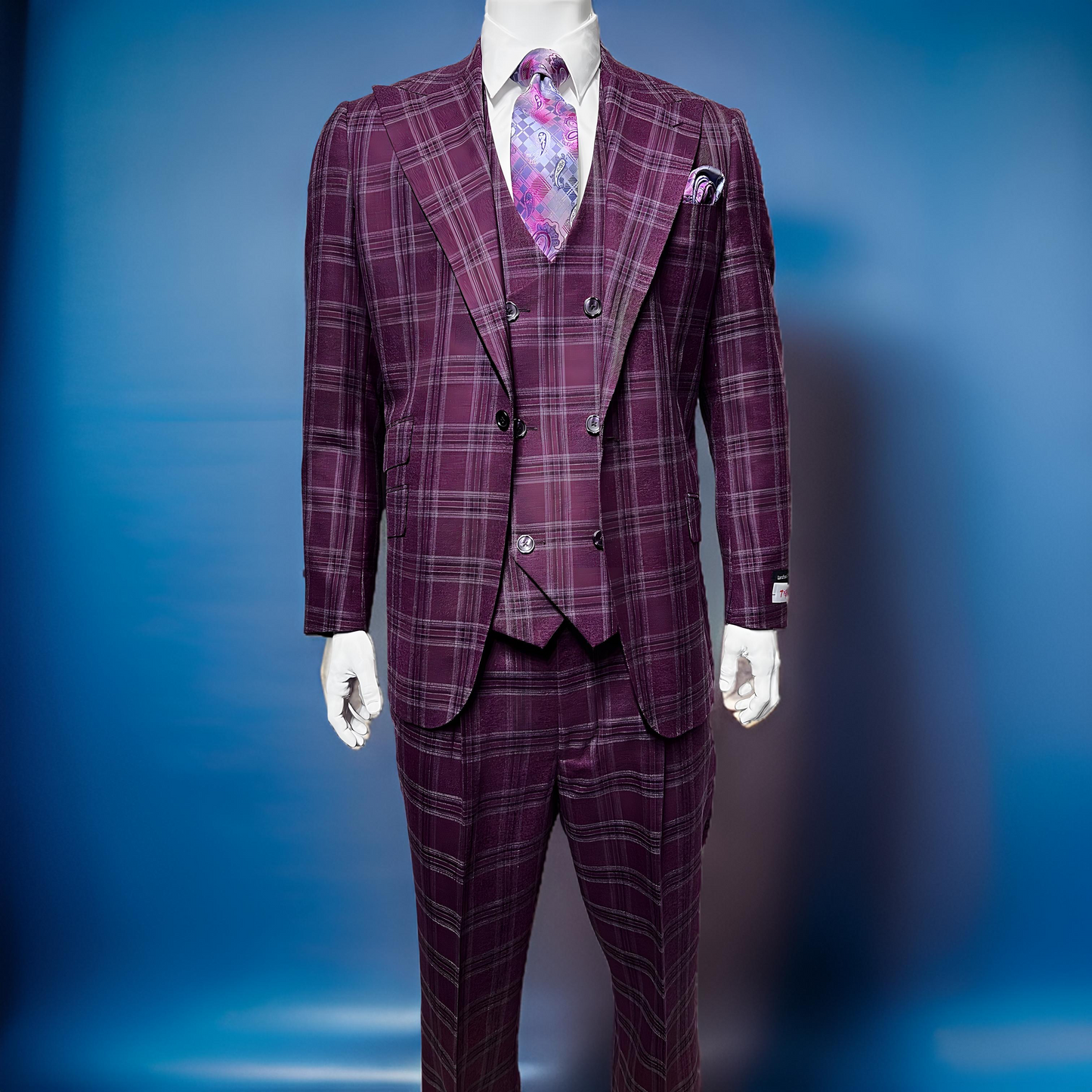 An older man stands against a plain background, wearing the Tiglio Rosso Orvietto Burgundy / Grey TL6336 suit with a matching vest, white shirt, and floral tie, showcasing the classic wide leg fit typical of Tiglio Rosso.