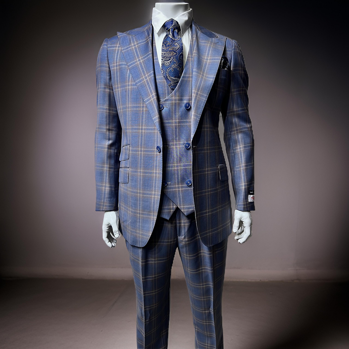 A mannequin displays the Tiglio Rosso Orvietto Blue / Light Brown TL6349 three-piece suit, crafted from 100% wool, with a paisley tie against a neutral background.