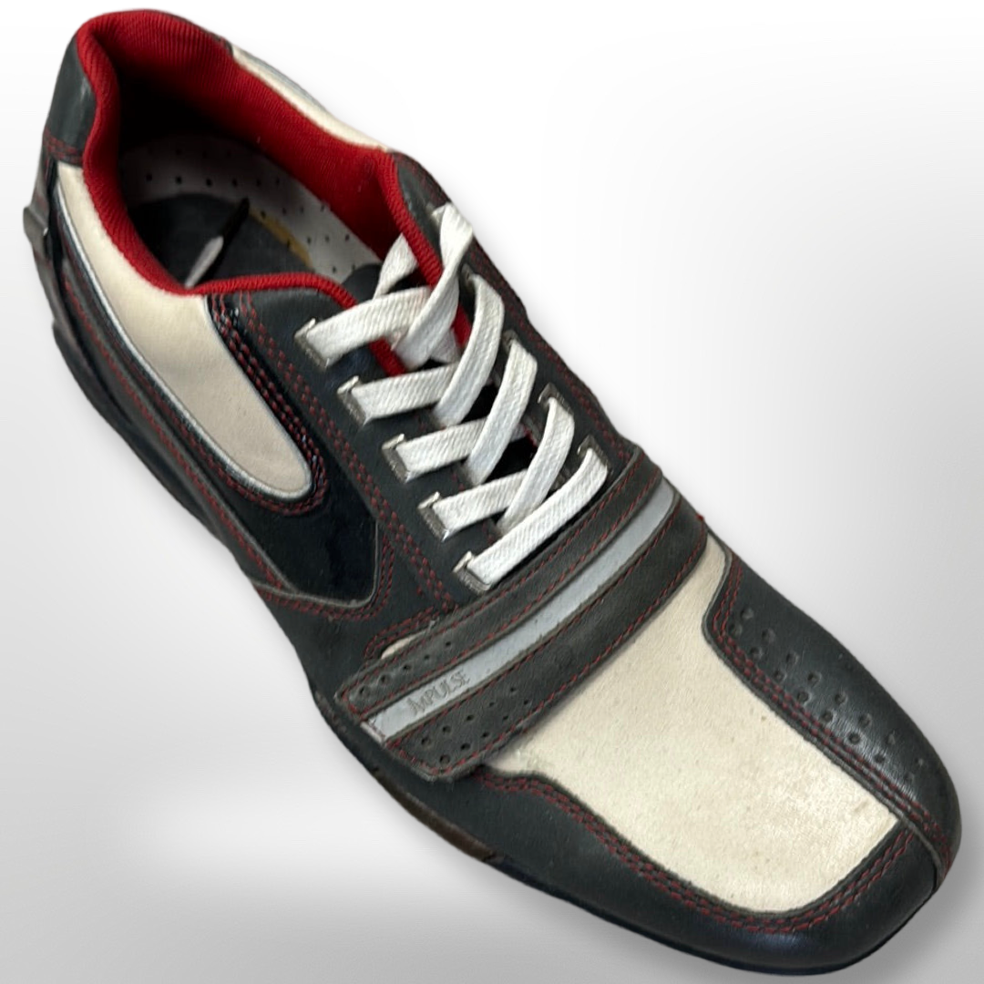 Introducing the "Shoe 52" by Fiesso: This sleek and contemporary black and white sneaker, accented with red details, showcases a stylish lace-up design and decorative stitching from an overhead perspective. Please note that this product is available in size 7 only and is offered as final sale, which means no returns or exchanges are possible.