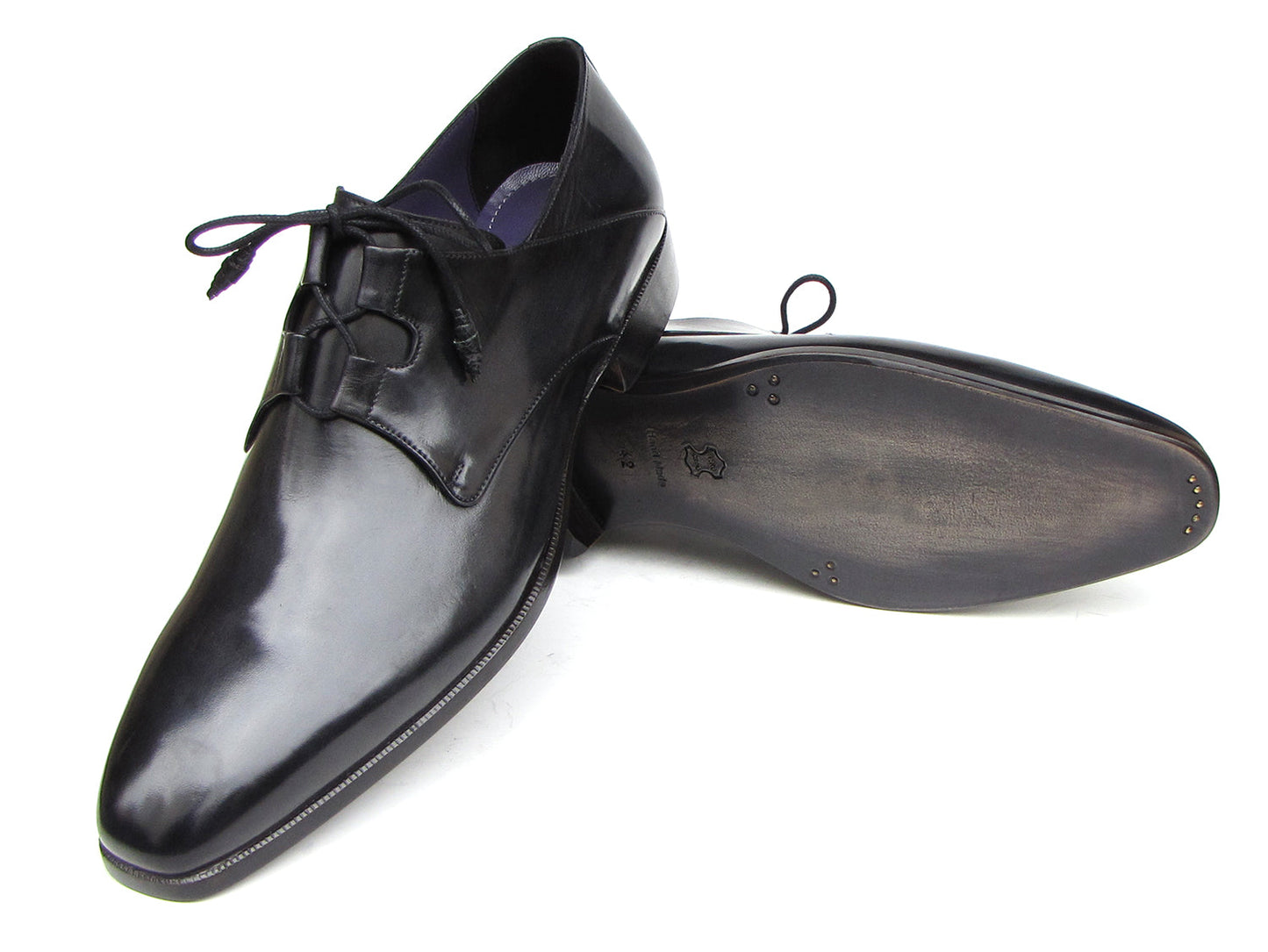 A pair of Paul Parkman Ghillie Lacing Plain Toe Black Shoes (076-BLK)—one shoe stands upright while the other rests on its side.