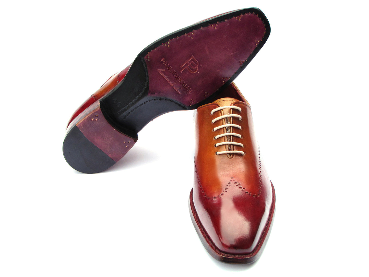 The Paul Parkman Goodyear Welted Wingtip Oxfords Bordeaux & Camel - 081-RDT feature two-tone brown and burgundy hues with brogue detailing, shown on a white background.