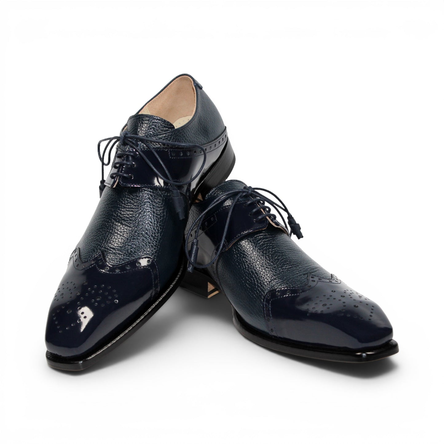 The Emilio Franco Luciano Navy by Emilio Franco is a luxury men's shoe in dark blue Italian leather, featuring brogue detailing, laces, and a low black heel, displayed on a white background.