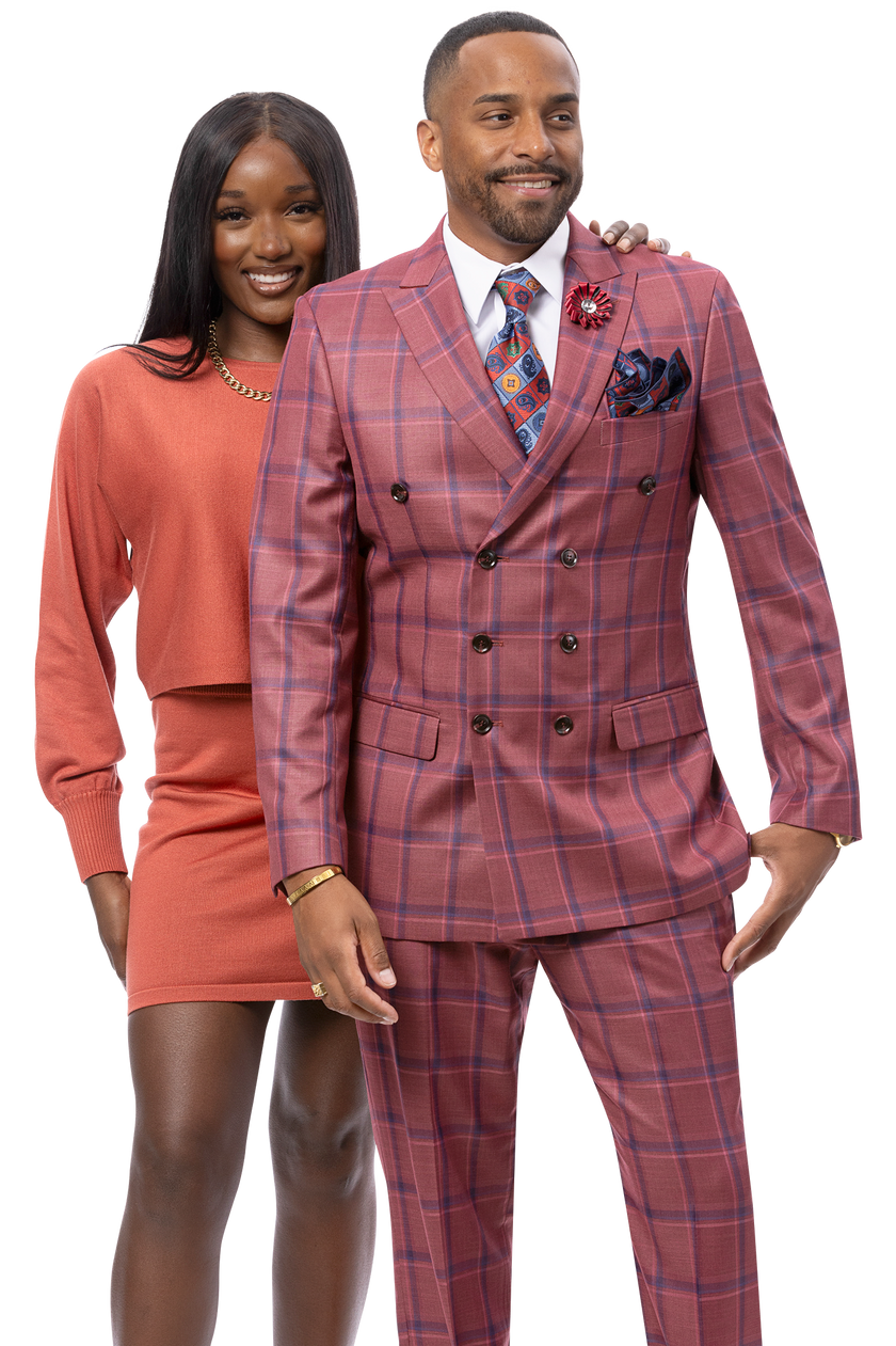 A woman in a rust-colored sweater and skirt stands behind a man dressed in the EJ SAMUEL Wine Suit M2813—a stylish double-breasted ensemble.