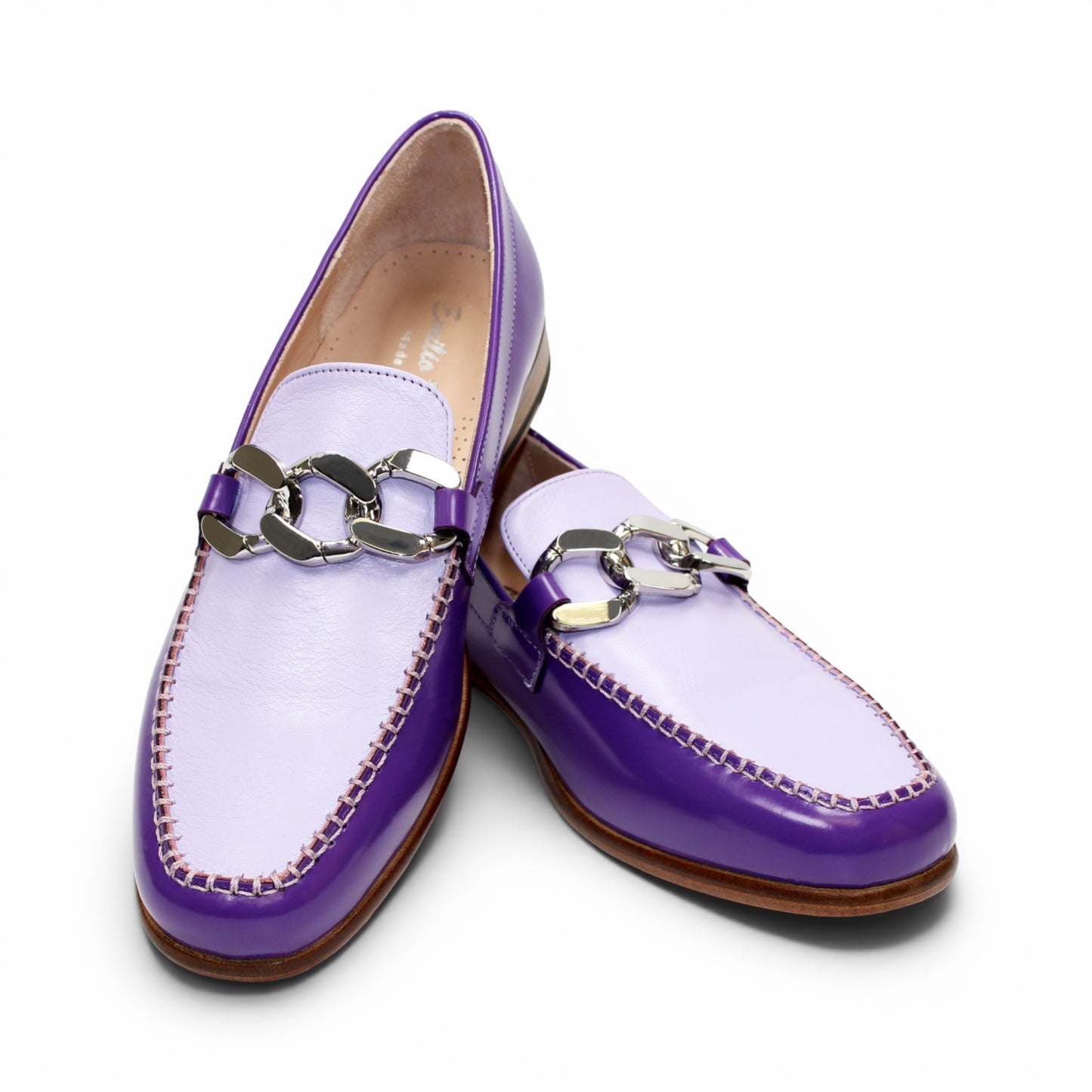The Emilio Franco M2 Purple/Lavender loafer is an Italian-crafted shoe featuring white stitching, a metal chain detail on the upper, and a brown wooden sole.