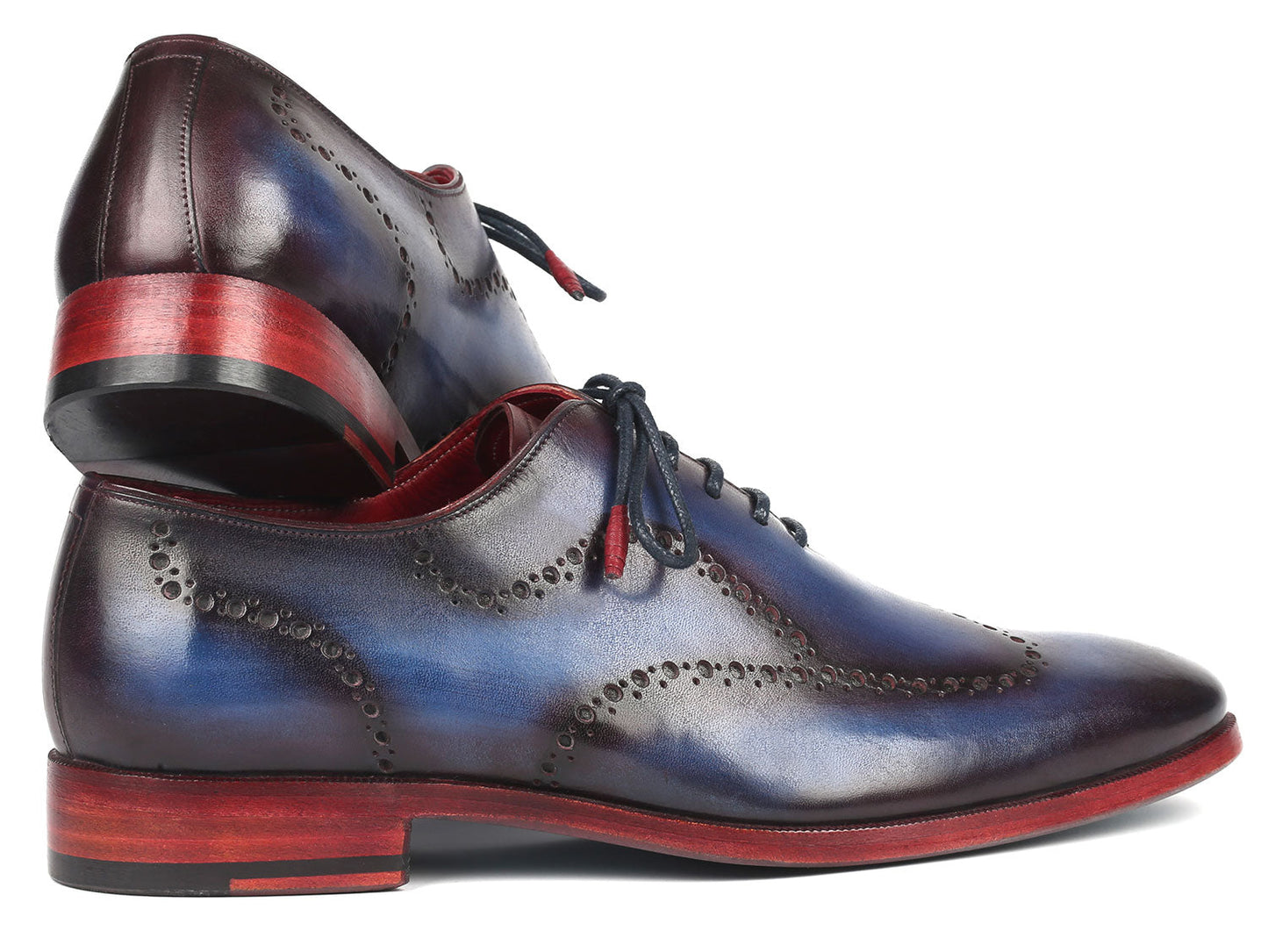 The Paul Parkman Wingtip Oxfords in Blue & Purple - 741-PRP are beautifully hand-painted calfskin dress shoes with red soles, showcasing intricate wingtip perforated designs.