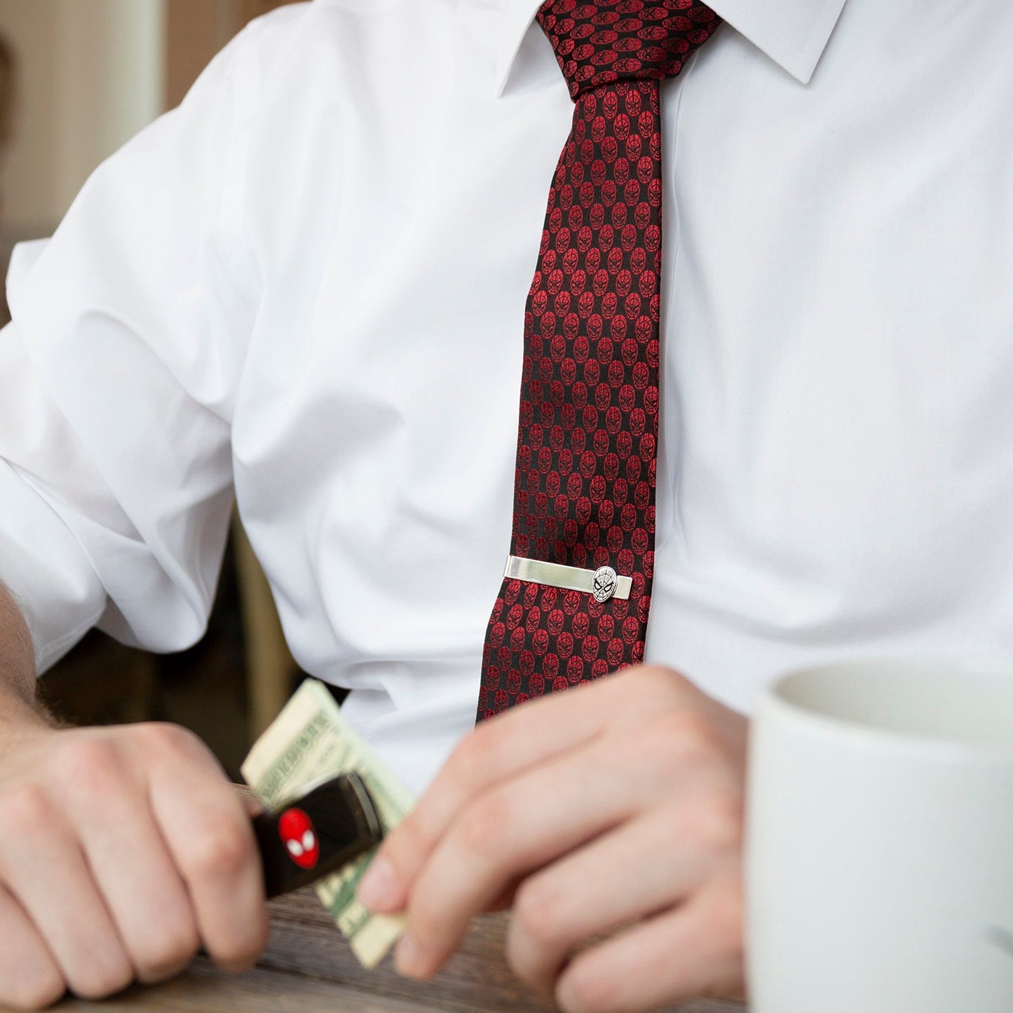 The Marvel Spider-Man Mask Red Men's Tie from Cufflinks.com features a crimson color with a black repeating design, crafted in silk and officially licensed, shown rolled up against a white background.