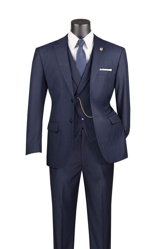 A mannequin displays the Vinci Suits Modern Fit 3 Piece Suit with Vest and Elastic Waist Band Pants (Navy) MV2TR, accompanied by a white shirt, blue tie, and pocket watch chain against a white background.