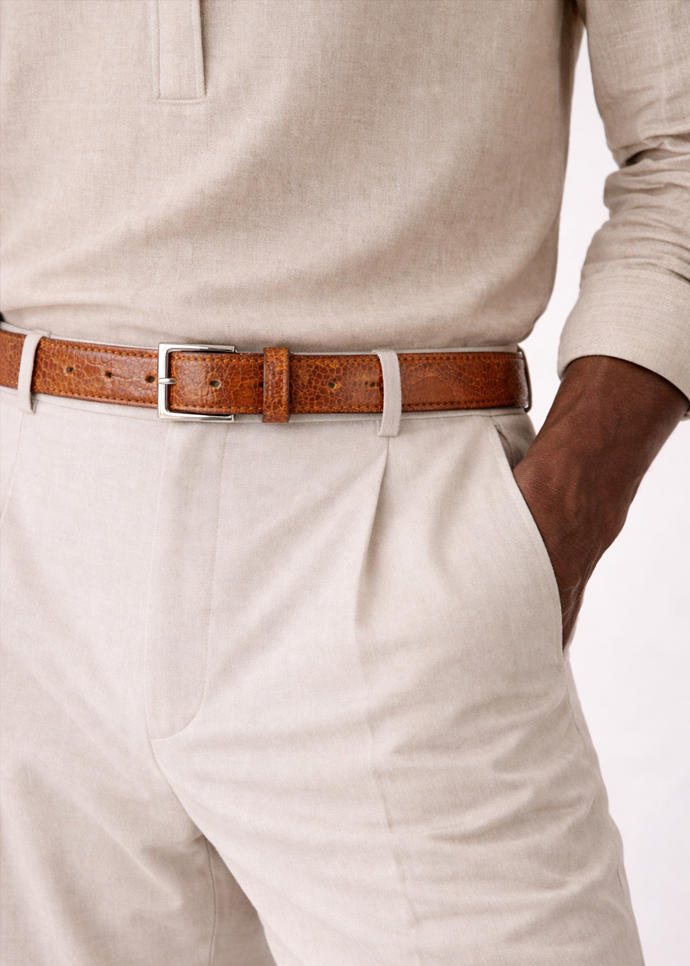 The BELVEDERE Ostrich Leg Belt Burned Amber 2000 features brown textured leather, a silver rectangular buckle, and multiple adjustment holes for a perfect fit. This size 44 adjustable belt is shown flat on a white background.