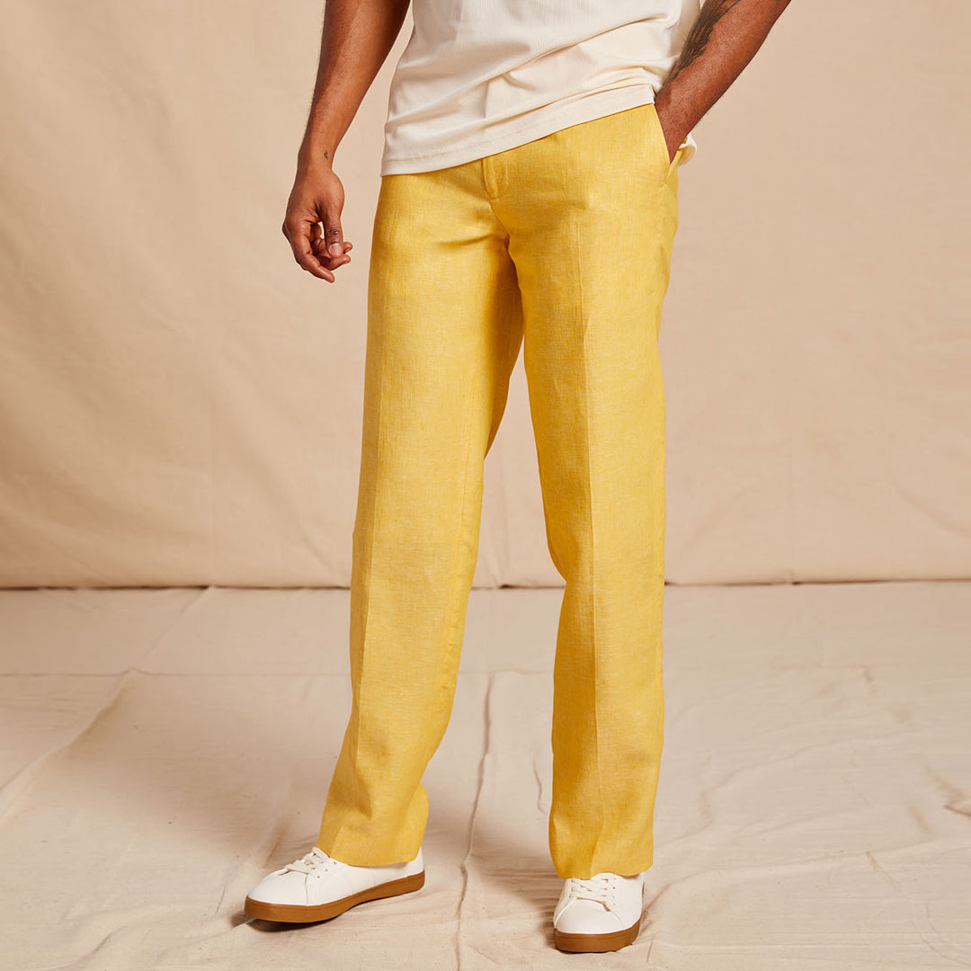 A man wears the Inserch Linen 2pc Set (SS718) Banana Cream—short-sleeve yellow button-up shirt with chest pockets and matching blue pants by Inserch, crafted from premium European flax linen for timeless comfort and elegance.